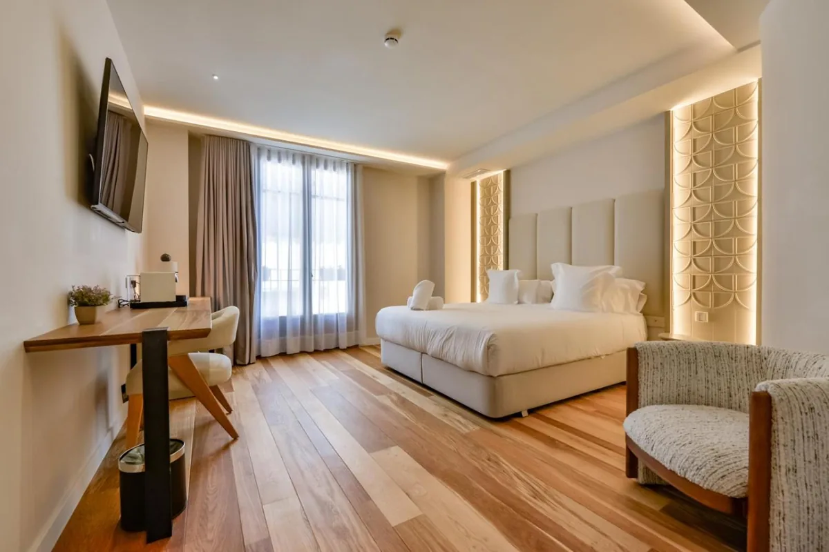 Suite bedroom with a desk and armchair at Las Torres