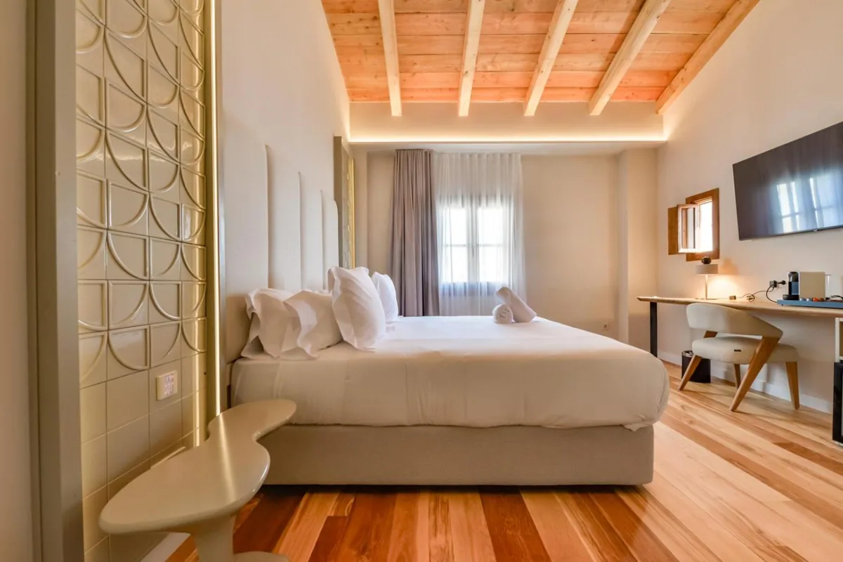 Suite bedroom with a timber ceiling at Las Torres