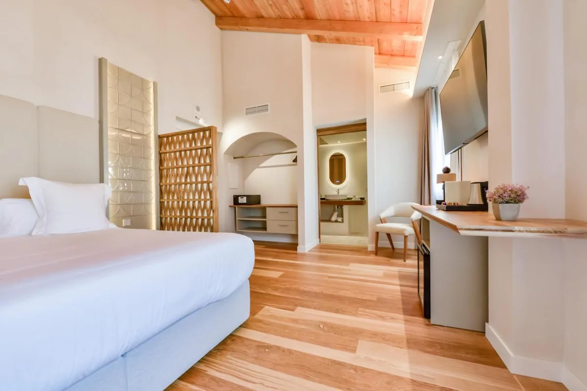 Suite bedroom with a timber ceiling and desk at Las Torres