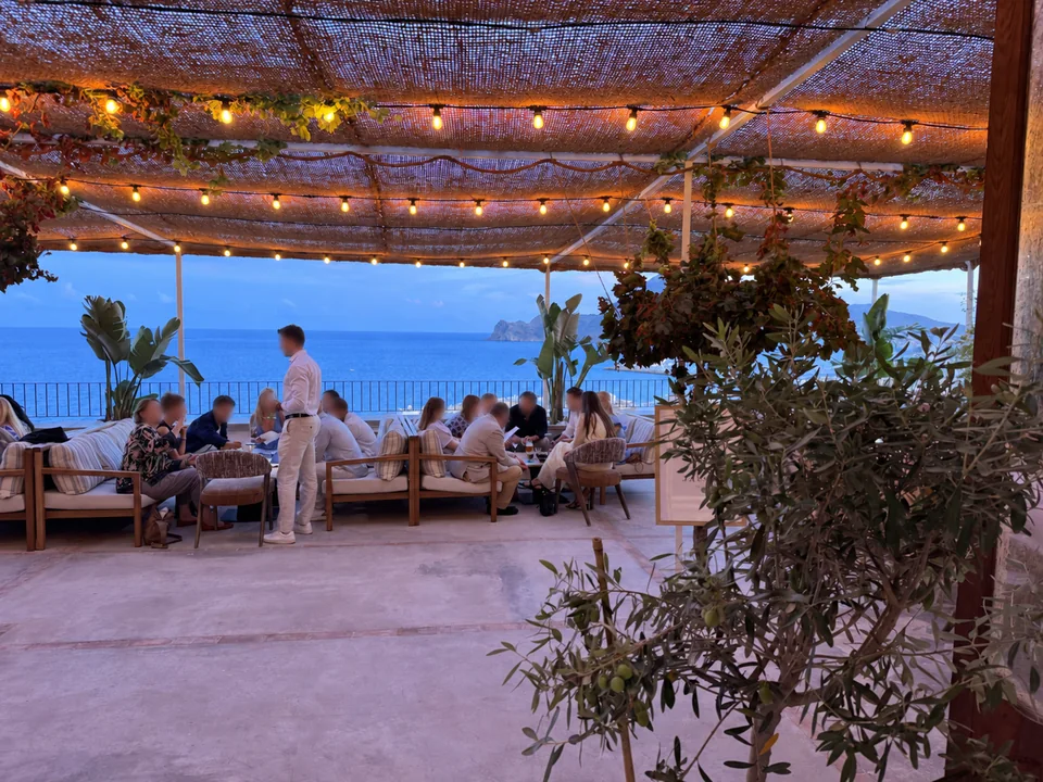 Guests enjoying the sea-view lounge terrace at Las Torres at dusk