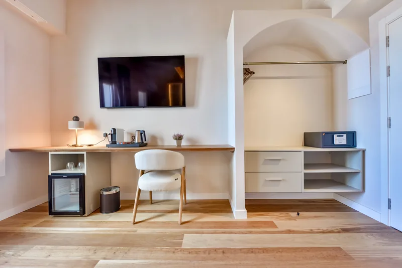 Desk, television and wardrobe in a Suite at Las Torres